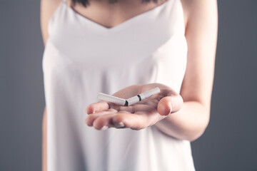 girl holding break cigarettes in her hands.