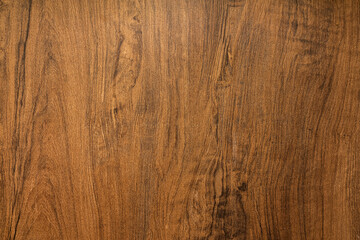 Background and texture of dark brown hardwood or oak wood surface in natural pattern. Close-up and selective focus at center part of photo. 