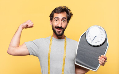 young crazy bearded man dieting happy expression and holding a sweight scale