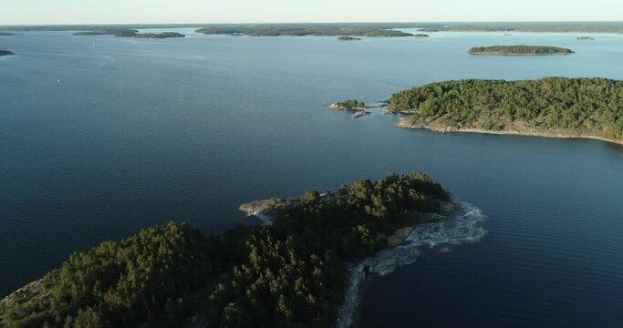 Aerial view of beautiful islands with green trees and rocks on the baltic sea at sunset. Colorful landscape with islands. Top view. Saaristomeri, Finland.