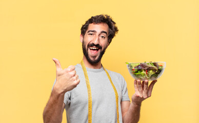 young crazy bearded man dieting happy expression and holding a salad
