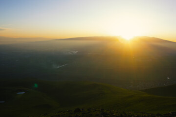 Sunset cloudy sky with the orange sun
