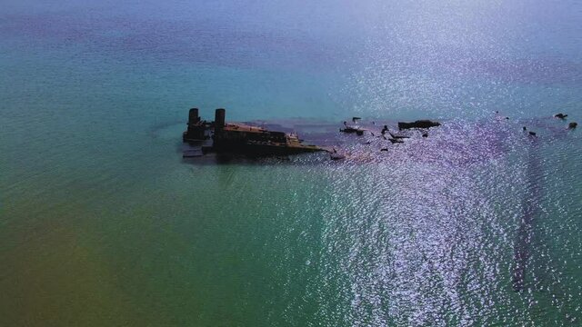 4K tilt up clip over a shipwreck in the  tropical beach of Epanomi, Norhtern Greece