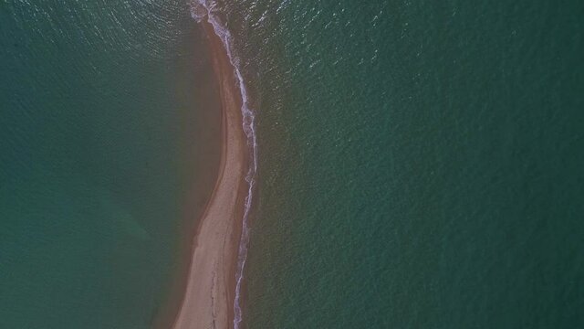4k overhead moving forward clip over a peninsula on  the tropical beach of Epanomi, Halkidiki, Greece