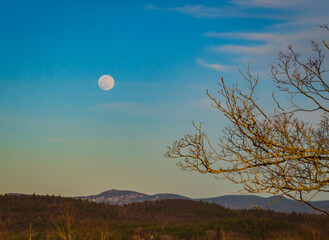full moon rising on a Vermont landscape
