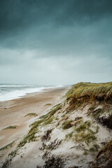Dramatic rainy spring day on the beach with wild windy ocean and white sand. Nationalpark Thy in North Jutland in Denmark on the danish Noth sea coast