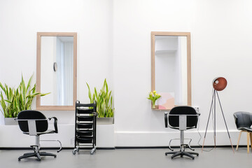 Workplace for hairdressers in barber shop. The interior of the hairdressing salon with a professional chairs and equipment is ready to receive visitors.