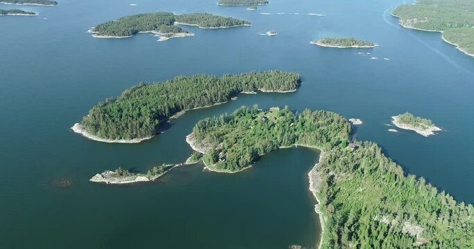 Aerial view of islands on the Baltic sea. Idyllic houses, huts on a small islands. Finland.