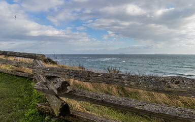 Fototapeta na wymiar View of the sea and a cedar fence