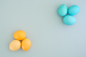 Minimalistic Easter composition on a gentle blue background with Easter eggs laid out in the shape of a flower. Space for text, flat lay, top view. Easter layout. Happy easter. Spring Festival