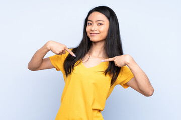 Teenager Chinese woman isolated on blue background proud and self-satisfied