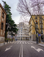 Obraz premium Madrid street with neoclassical buildings of different colors and typical balconies.