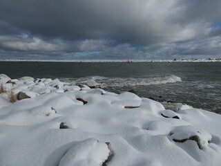 Winter seascape with stones covered with snow, Górki Zachodnie, Bay of Gdansk, Poland