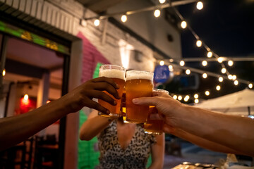 Group of friends toasting with beer