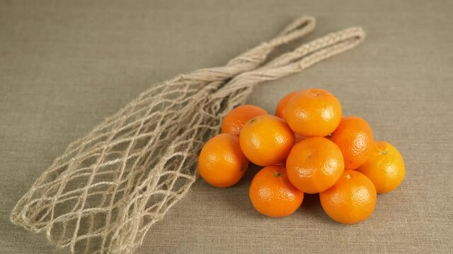 Oranges in shopping bag. Tangerines with a string bag.