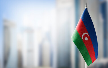 A small flag of Azerbaijan on the background of a blurred background