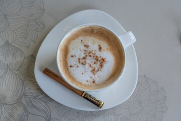 top view of a cup of coffee with a wonderful crema and chocolate powder - business class lifestyle 