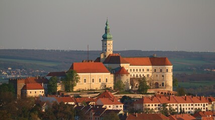 Obraz premium A view to the beautiful city castle during golden sunset at historical city Mikulov, Czech republic
