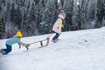 Kids riding sledding slide. Children on snow landscape, winter snowy fun activities. Sled speed...