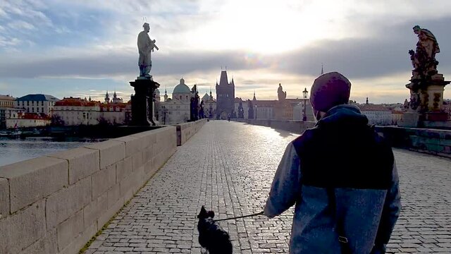 Man walking a Border Collie on Charles bridge Prage