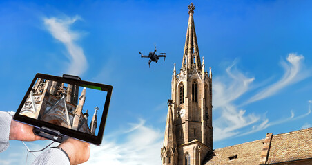 Drone in the air inspecting church tower and ornaments. Close-up of display with defective...