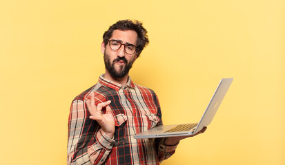 young crazy bearded man happy expression and a laptop