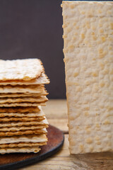 Matza sheets on a round stand on a wooden table. copy space.