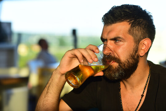 Beer pub and bar. Hipster with beard and mustache in suit drinks beer after working day.