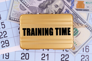 On the table lies a calendar, money and a briefcase with the inscription - TRAINING TIME