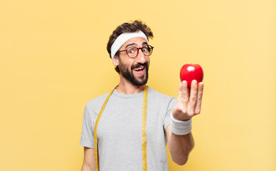 young crazy bearded athlete happy expression and holding an apple and holding an apple