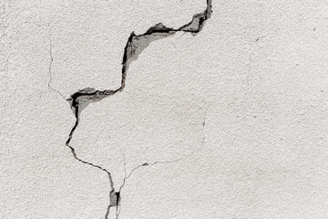 Crack on a grey concrete wall of abandoned house in Al Madam ghost village in United Arab Emirates, industrial background.