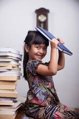 Portrait of cute little girl reading book and study at home schooling 