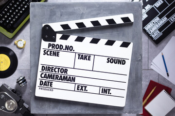 Movie clapboard or  clapper at old table. Clapperboard and screenwriter or movie writer concept
