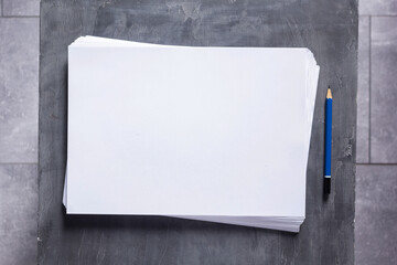 Stack of paper sheet with empty pages on table background. Creative idea concept - obrazy, fototapety, plakaty
