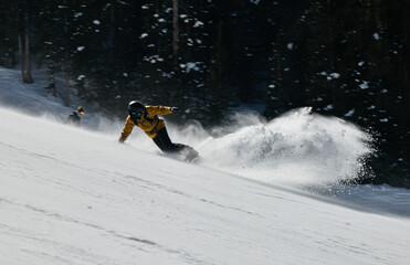 Man snowboarding on snowy hill. Extreme winter sports. Action shot. Vail ski resort, Colorado