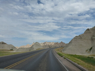 A road going through the surreal landscape and terrain at Badlands National Park in South Dakota