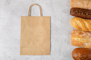 Baking background with eco disposable paper bag from a supermarket recyclable and whole fresh baked...