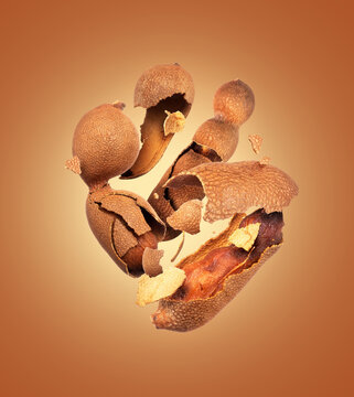 Crushed tamarind in the air close up on a brown background
