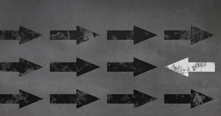 Digital animation of multiple black and white arrows moving against grey background