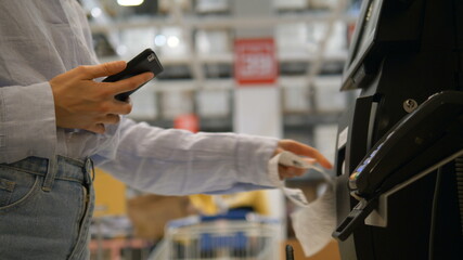 girl clicks on terminal monitor and carries out online purchase using Apple Pay service slow motion extreme closeup