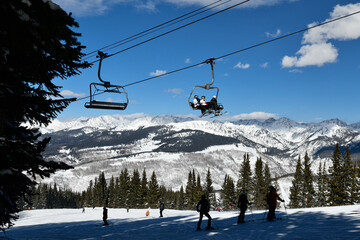 Ski chair lift with skiers. Ski resort in Vail, Colorado, USA - obrazy, fototapety, plakaty