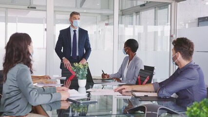 Business people wearing mask and keeping social distancing during meeting - Powered by Adobe