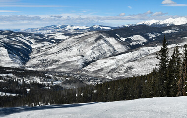 Fototapeta na wymiar View to the mountains from the top angle. Sunny day at Vail Ski resort, Colorado, USA