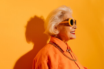 Woman looking away, toothy smiling and feeling pleasure while posing
