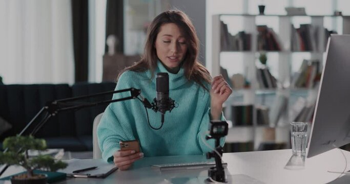 Caucasian optimistic young woman recording audio podcast talking on camera training business tutorial freelancer tips sharing news communicating online.