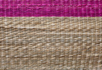 wicker basket with a rose-colored top and the rest in natural co