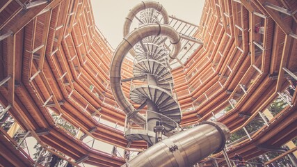 Big slide in the interior of wooden observation tower. Tree top walk trail, Krkonose. Toned picture