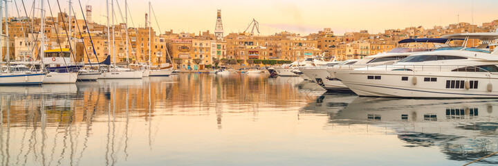 Fototapeta na wymiar Rows of sailing boats on Senglea marina, Malta