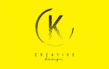 K letter logo design with black dots and circle frame on bright yellow background.