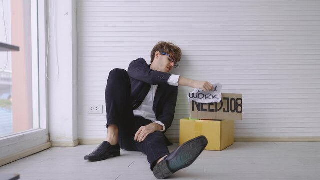 The dismissed company employee was sad. He subsided, wanting to be exhausted by the glass wall.
